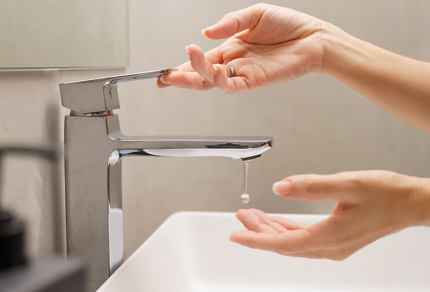 Water crisis, woman washing her hands
