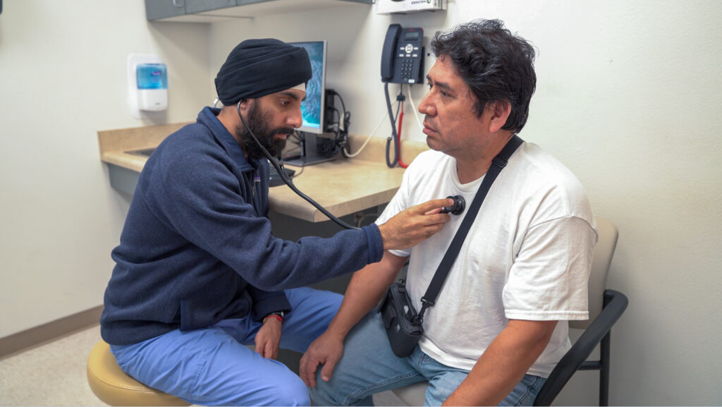 doctor checks a patients heartbeat in a comfortable and private exam room