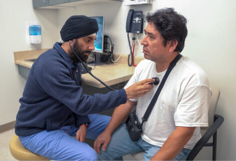 doctor checks a patients heartbeat in a comfortable and private exam room
