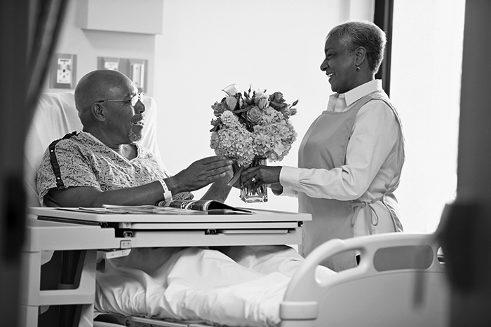 Volunteer bringing patient flowers