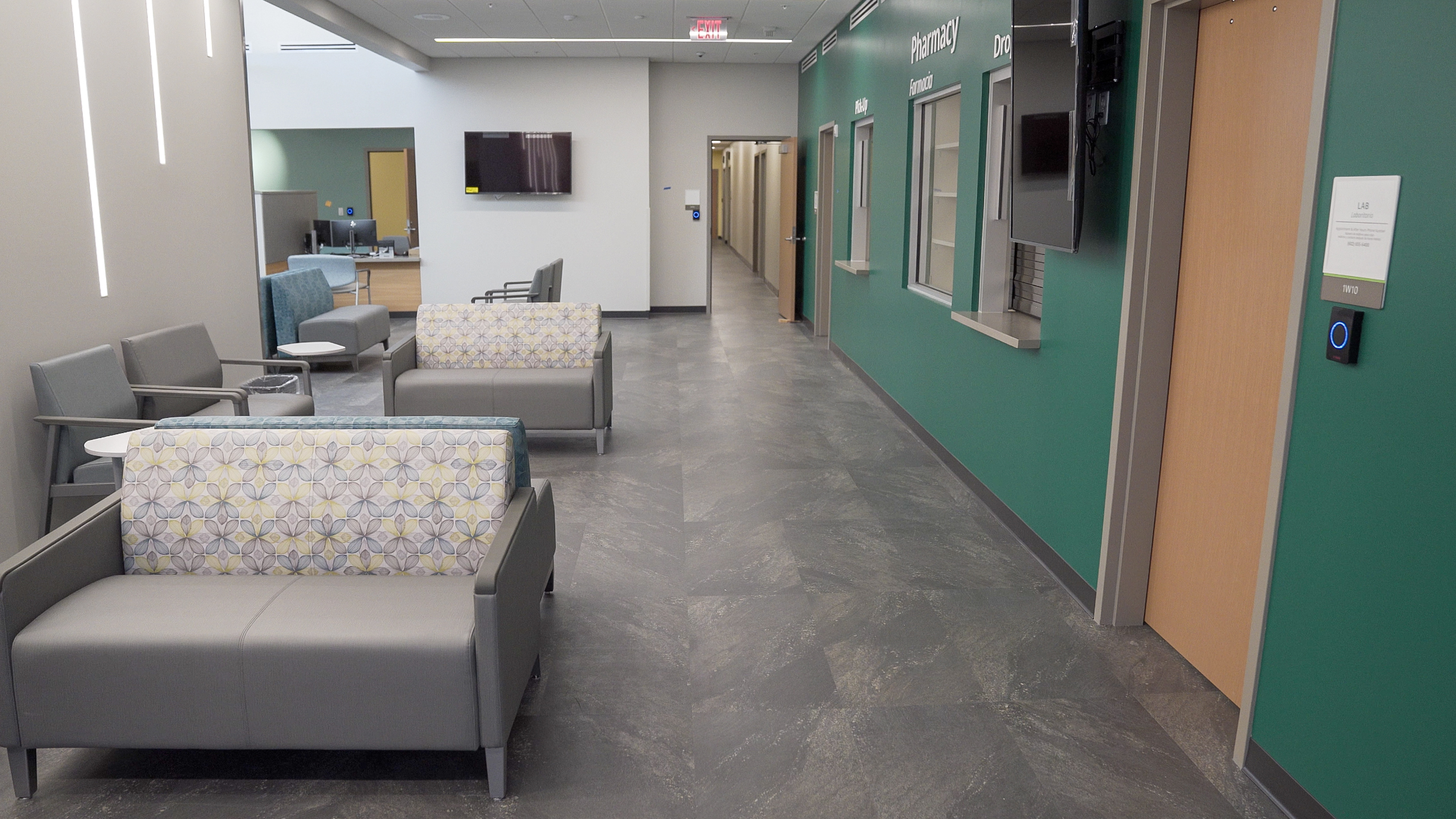 waiting room inside a medical center with gray seats